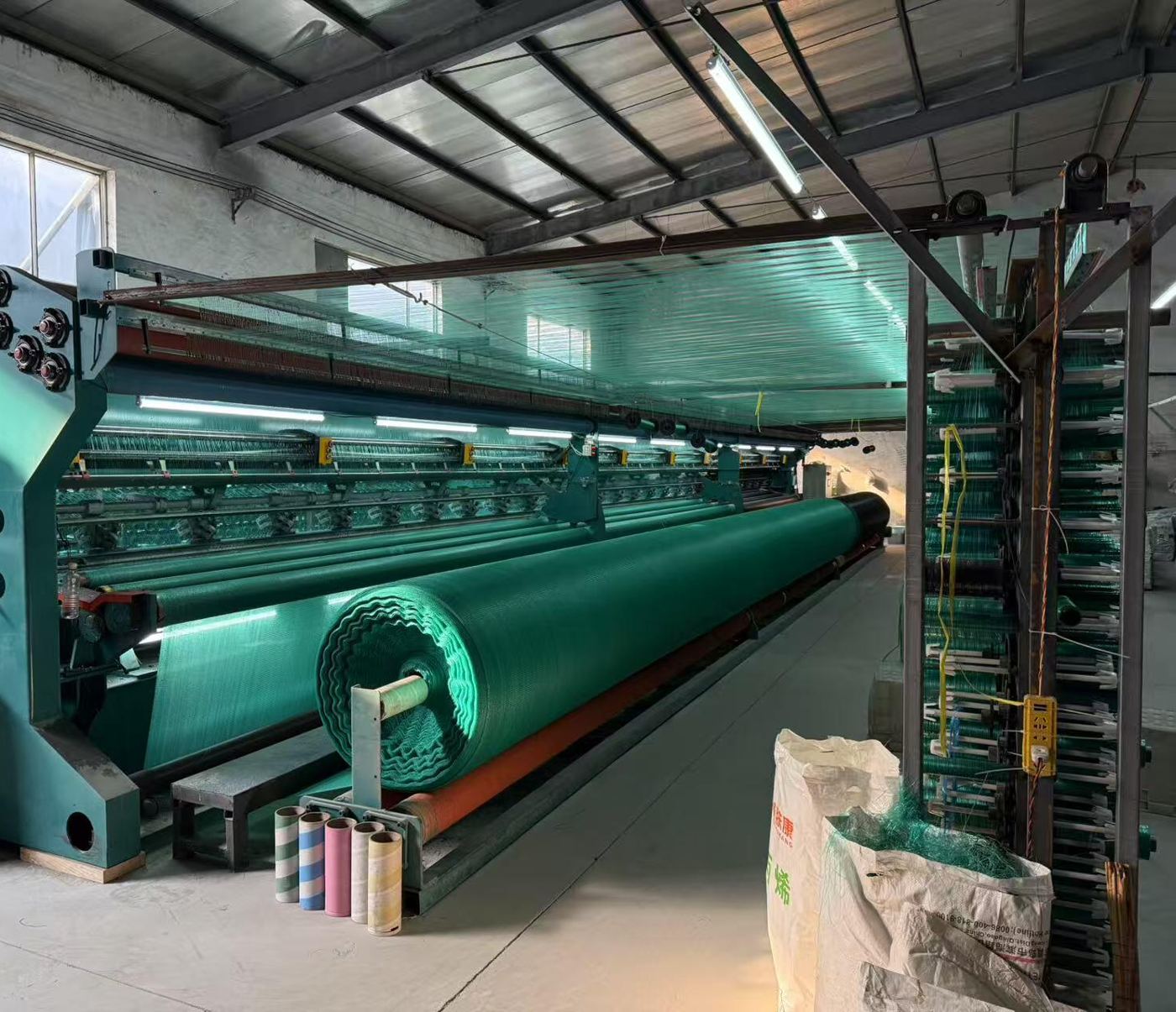 Net knitting machine producing green netting